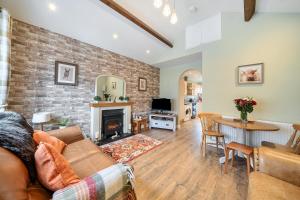 a living room with a couch and a fireplace at Central Ripon - Sleeps 3 - Garden - Pet Friendly in Ripon