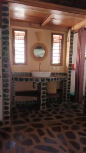 a bathroom with a sink and a mirror at Ravoravo Beachfront Family lodge in Lokobe National Park-Nosy be, autentic Madagascar expiriance with europian confort in Antafondro +95 photos
