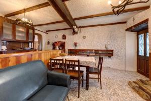 a kitchen and dining room with a table and chairs at Casa Fenera in Valduggia +23 photos