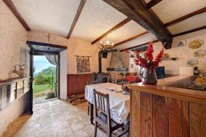 a kitchen and dining room with a table and a window at Casa Fenera in Valduggia