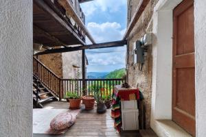 a balcony with potted plants on a building at Casa Fenera in Valduggia