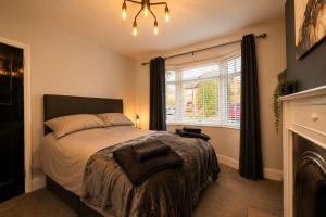 a bedroom with a large bed and a window at Super Modern 3 bedroom semi-detached. in Rugby