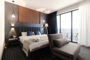 a hotel room with a bed and a chair at NOVA LUXE Hotel & Residences in Batumi +50 photos