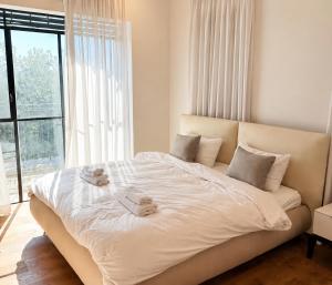 a bedroom with a large bed with towels on it at Casa del Barone - וילה יוקרתית עם בריכה פרטית in Kefar Tavor +14 photos