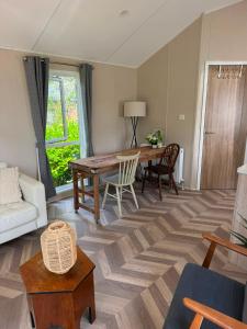 a living room with a table and a couch at Zonnestraal in Harderwijk