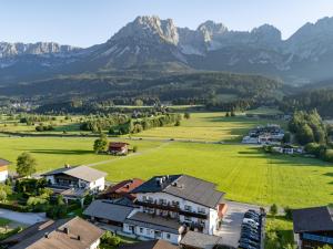 an aerial view of a village with mountains in the background at Hotel Ritterhof Ellmau in Ellmau