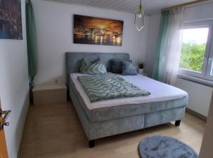 a bedroom with a bed and a window at Ferienhaus Spengler in Beuren