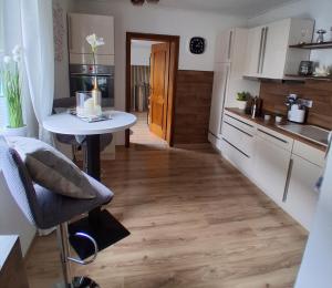 a small kitchen with a table and a table at Ferienhaus Spengler in Beuren +9 photos