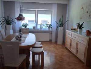 a dining room with a table and some potted plants at Ferienhaus Spengler in Beuren