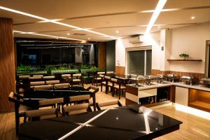 a restaurant with tables and chairs in a room at Athirappilly Rainland Resort in Athirappilly