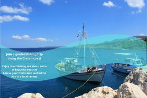 two boats are tied to rocks in the water at FabView Studio Apartments in Panormos Rethymno