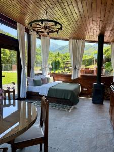 a bedroom with a bed and a table and window at The Heaven Sibiu in Sebeşu de Sus