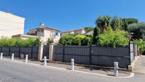 a black fence on the side of a street at Studio Villa Monica in Vallauris