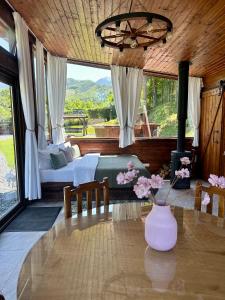 a bedroom with a bed and a table with flowers on it at The Heaven Sibiu in Sebeşu de Sus