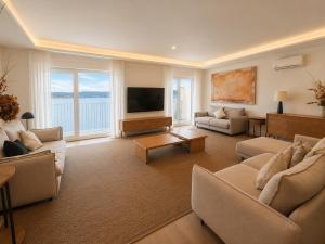 a living room with couches and a flat screen tv at Blue Ocean Deluxe in Sanxenxo