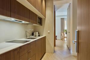 a kitchen with a sink and a counter top at Glinter Barrio de las Letras - Apartments in Madrid
