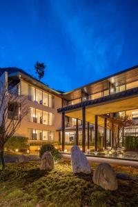 a large building with rocks in front of it at Magnolia Maison in Garze
