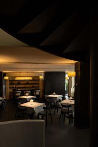 a dining room with tables and chairs and a chalkboard at Magnolia Maison in Garze