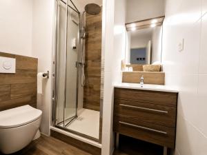 a bathroom with a shower and a toilet and a sink at Hôtel-Restaurant La Belle Poule - in Rochefort