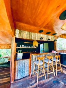 a bar in a cabin with two chairs and a table at Villa Marcelinus in Kelimutu
