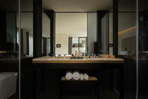 a bathroom with a sink and a large mirror at Magnolia Maison in Garze +105 photos