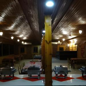 a large room with tables and a ceiling with lights at elwaharesort in Wāsiţ