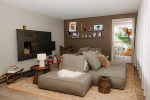 a living room with a couch and a fireplace at OVERLOOK Lodge by CERVO Zermatt in Zermatt