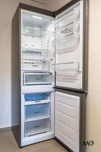 an empty refrigerator with its door open in a kitchen at Noua Suites in Braşov