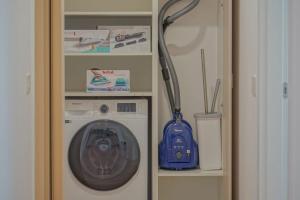 a washer and dryer in a small room with aiger at Noua Suites in Braşov
