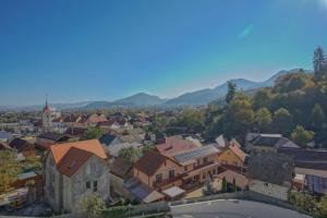 a view of a town with mountains in the background at Noua Suites in Braşov