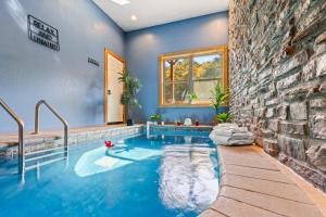 a swimming pool in the middle of a house at Rustic Mountain Retreat by Ghosal Luxury Lodging in Pigeon Forge