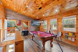 a pool table in a room with wooden walls at Rustic Mountain Retreat by Ghosal Luxury Lodging in Pigeon Forge