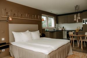 a bedroom with a large bed and a kitchen at OVERLOOK Lodge by CERVO Zermatt in Zermatt