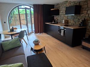 a living room with a couch and a table at La Cachette de Simone in Spa