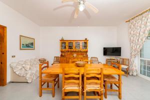 a dining room with a wooden table and chairs at Villa Cesare in Torre Specchia Ruggeri