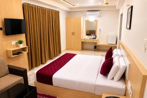 a hotel room with a bed and a chair at Athirappilly Rainland Resort in Athirappilly