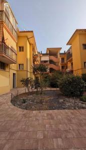 a group of buildings with trees in a courtyard at Casa Gigi a Sottomarina in Chioggia