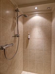 a shower with a shower head in a bathroom at Mas de Fauchon - Teritoria in Saint-Cannat +49 photos