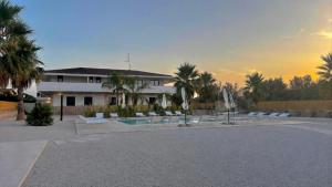 a building with a lot of chairs and a pool at B&B Helios in Nardò