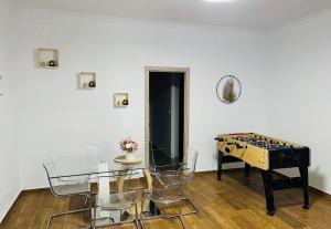a dining room with a glass table and a chessboard at Villa Mia in Marchena