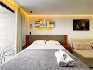 a bedroom with a bed with two towels on it at Summer by Hosppedar in Ilha da Restinga +123 photos