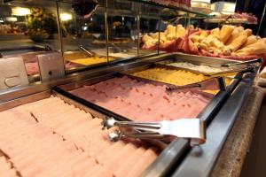 a buffet line with many different types of food at Mengo Palace Hotel in Rio de Janeiro