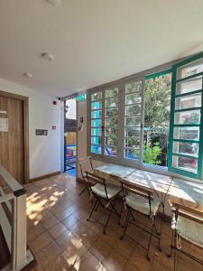 a dining room with a table and chairs and windows at Harrys Inn Guesthouse in Larnaca +31 photos