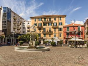 a fountain in a square in a city with buildings at Gramsci House - Sea 3 min - Central - Family in Vado Ligure