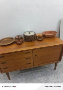 a wooden table with bowls and plates on top of it at Atupim Royal in Janman