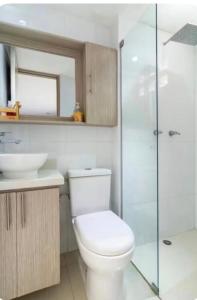 a bathroom with a toilet and a sink and a shower at Loft Premium El Poblado in Envigado