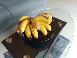 a bunch of bananas sitting on a glass table at Le ptit coin mont vert in Saint-Pierre +19 photos