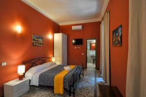 a bedroom with orange walls and a bed in a room at Antica Terrazza Frascati in Frascati +131 photos