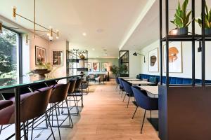 a bar with chairs and tables in a restaurant at Argyl - The Apiary, Ealing in Ealing