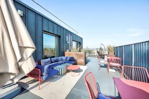 a patio with chairs and tables on a building at Argyl - The Apiary, Ealing in Ealing